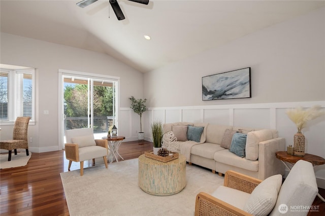 living room with lofted ceiling, ceiling fan, wood-type flooring, a decorative wall, and recessed lighting