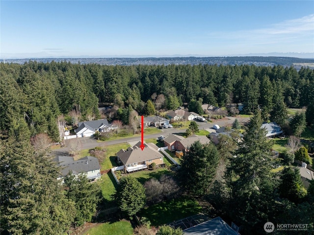 aerial view with a residential view and a view of trees