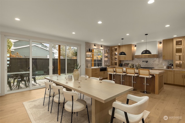 dining area featuring sink and light hardwood / wood-style flooring