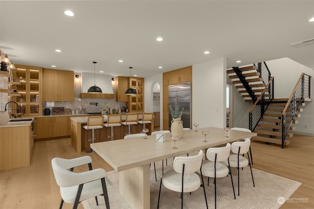 dining space featuring sink and light hardwood / wood-style flooring