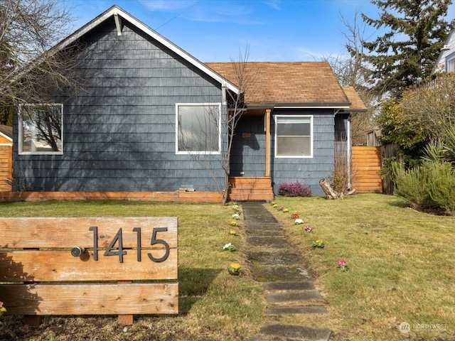 bungalow-style house featuring a front yard