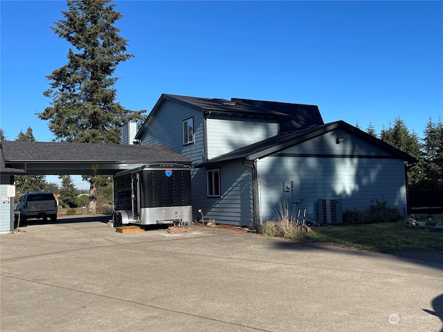 exterior space featuring a carport and central AC unit