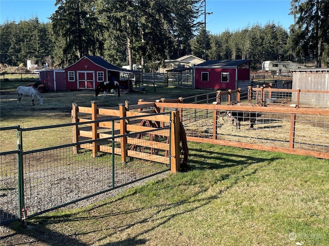 view of yard featuring an outdoor structure and a rural view