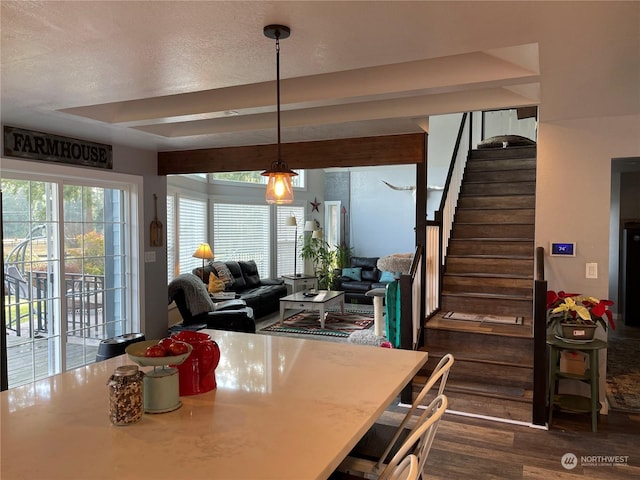 dining room featuring dark hardwood / wood-style flooring and a textured ceiling