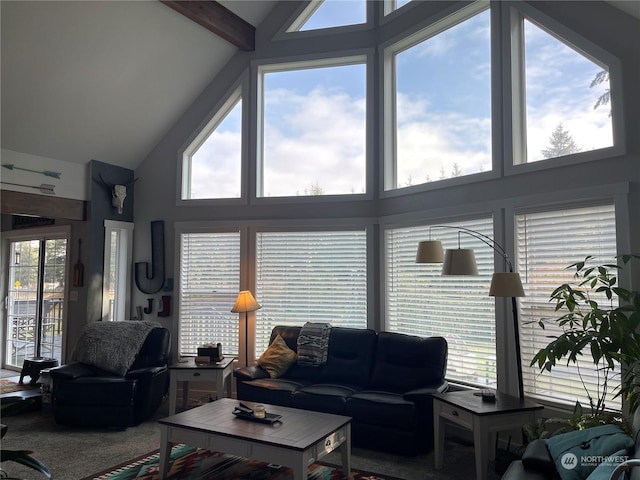 carpeted living room featuring beamed ceiling, a healthy amount of sunlight, and high vaulted ceiling