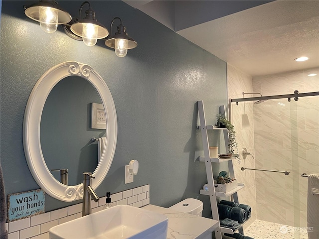 bathroom featuring toilet, sink, a textured ceiling, and a shower with shower door