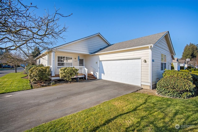 single story home featuring a garage, covered porch, and a front lawn