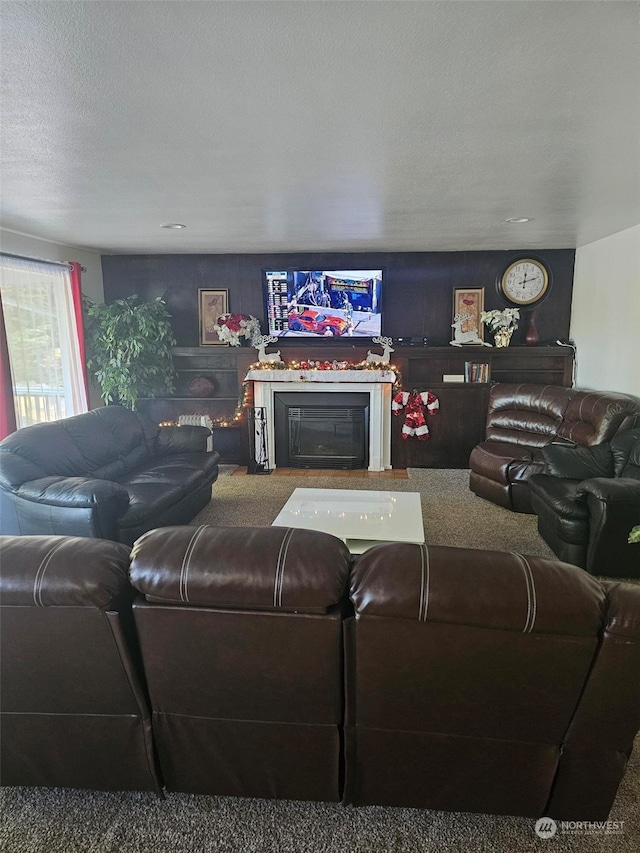 living room with a textured ceiling and a fireplace