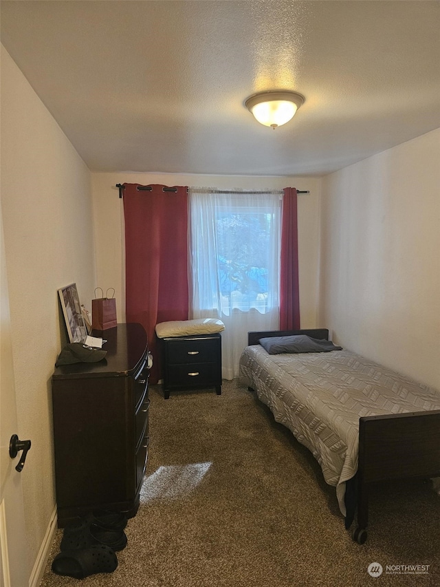 carpeted bedroom featuring a textured ceiling