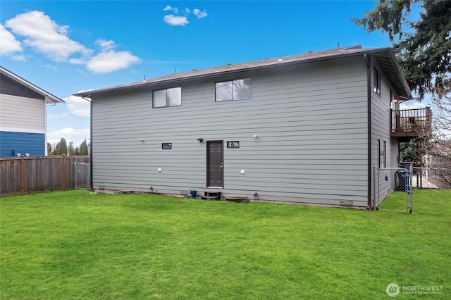 back of house featuring crawl space, a fenced backyard, and a yard