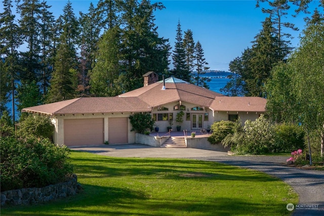 view of front of home with a garage and a front lawn