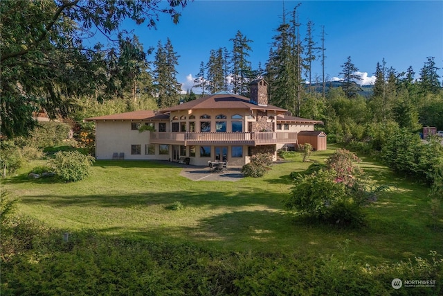 rear view of house with a yard, a patio area, and a deck