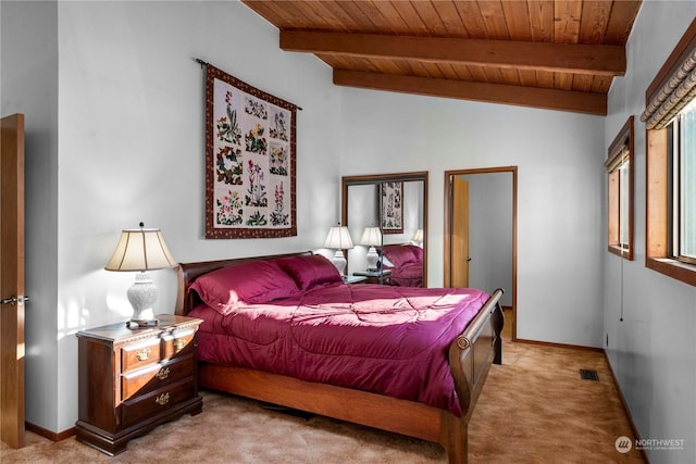 bedroom with lofted ceiling with beams, light carpet, and wooden ceiling