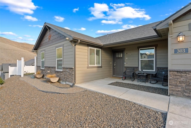 view of front of home featuring a mountain view and a patio area