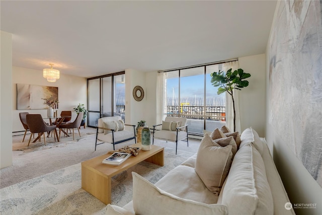 living room with expansive windows, a baseboard radiator, light colored carpet, and a chandelier