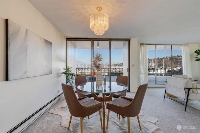 carpeted dining room featuring a baseboard heating unit, an inviting chandelier, and a wall of windows