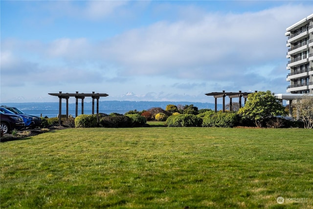 exterior space with a water view and a lawn