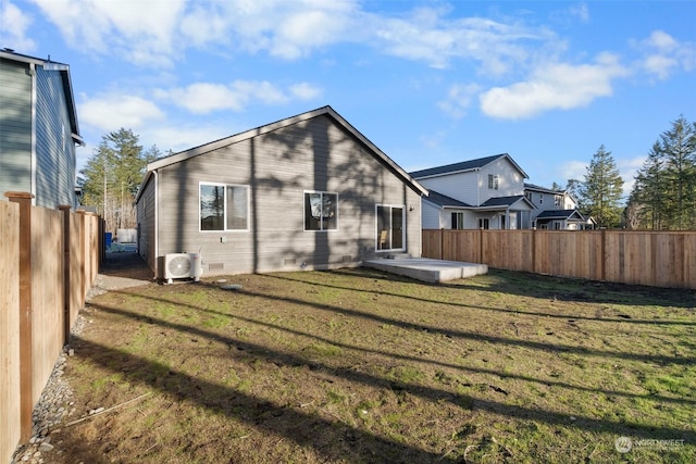 rear view of house featuring a patio, ac unit, and a lawn