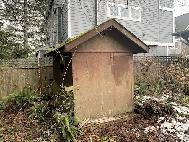 view of shed featuring fence