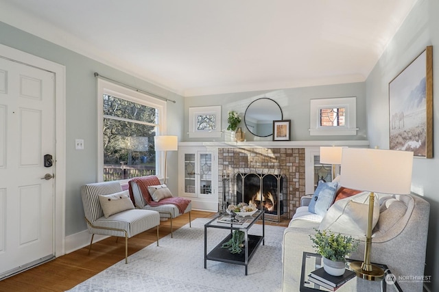 living room featuring a brick fireplace and hardwood / wood-style floors