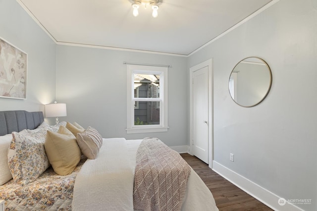 bedroom featuring crown molding and dark hardwood / wood-style floors