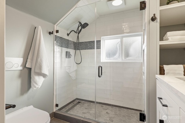 bathroom with walk in shower, vanity, and toilet