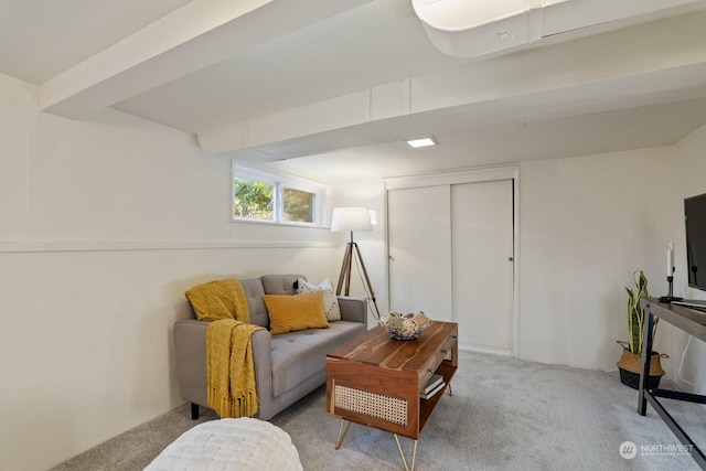 sitting room with light carpet and beam ceiling