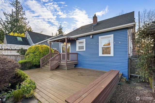 rear view of house featuring a wooden deck