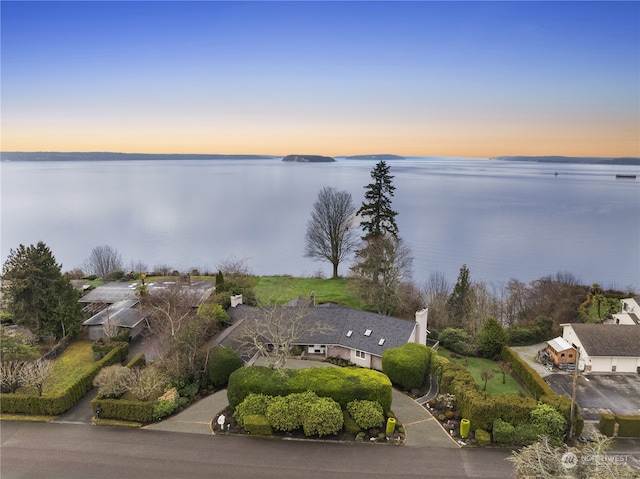 aerial view at dusk with a water view