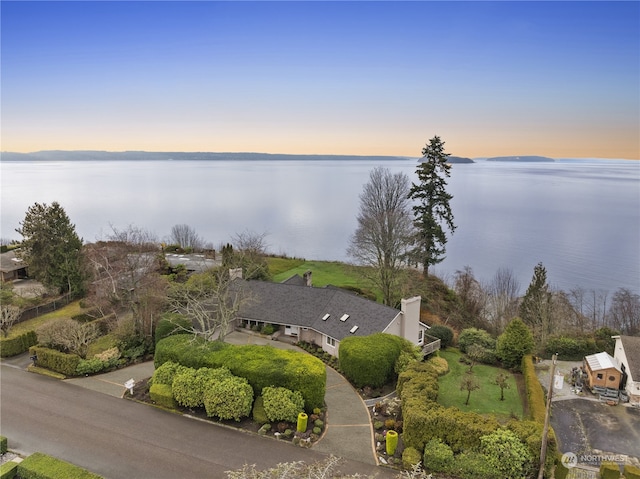 aerial view at dusk with a water view