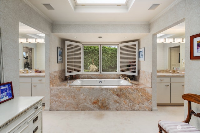 bathroom with ornamental molding, a skylight, vanity, and tiled tub