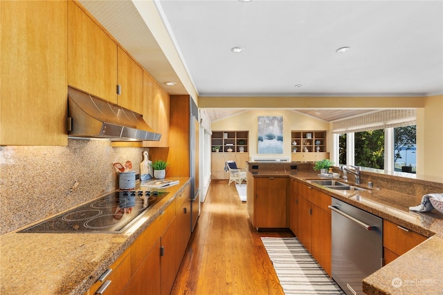 kitchen featuring sink, light hardwood / wood-style flooring, range hood, black electric stovetop, and stainless steel dishwasher