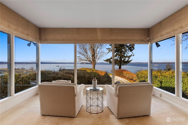 unfurnished sunroom featuring a water view