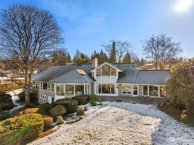 back of house with a sunroom