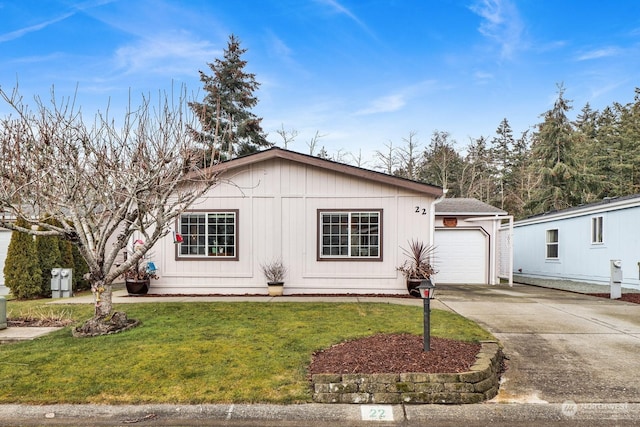 view of front of home featuring a garage and a front lawn