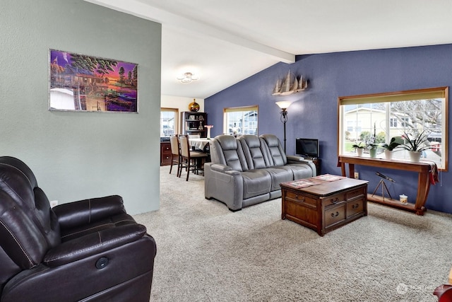 carpeted living room with lofted ceiling with beams