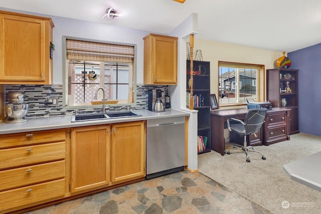 kitchen featuring tasteful backsplash, dishwasher, sink, and light carpet