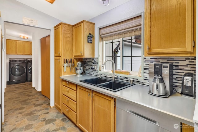 kitchen featuring washer and dryer, sink, and backsplash