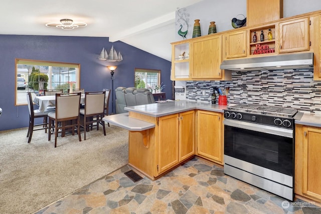 kitchen featuring stainless steel gas range, tasteful backsplash, lofted ceiling with beams, kitchen peninsula, and light colored carpet