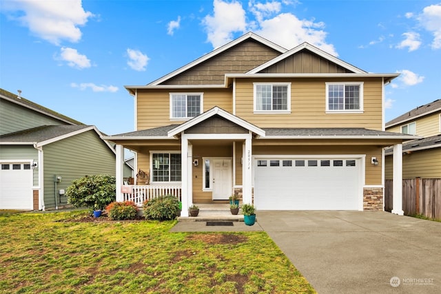 craftsman inspired home with a garage, covered porch, and a front yard