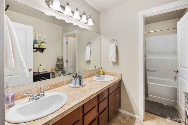 bathroom with vanity, tile patterned floors, and washtub / shower combination