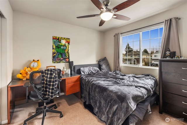 bedroom featuring light colored carpet and ceiling fan