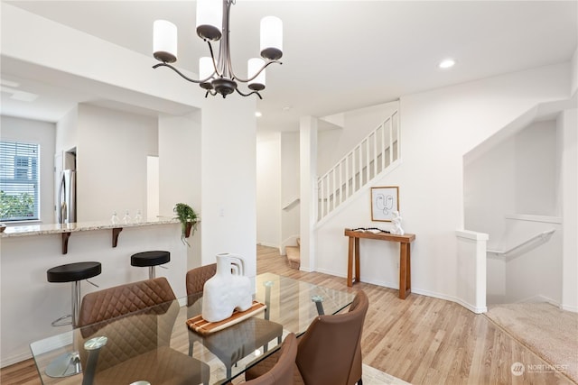 dining area featuring a chandelier and light hardwood / wood-style floors