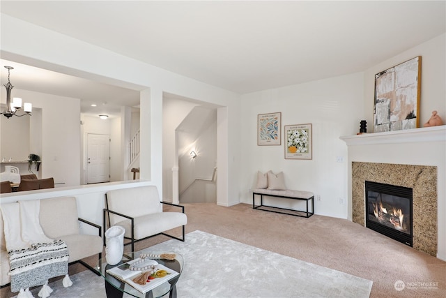 living room featuring carpet flooring and a notable chandelier