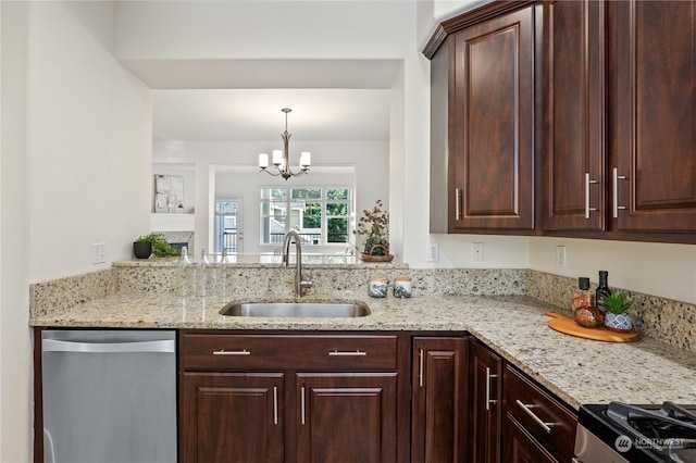 kitchen featuring sink, decorative light fixtures, light stone countertops, and appliances with stainless steel finishes