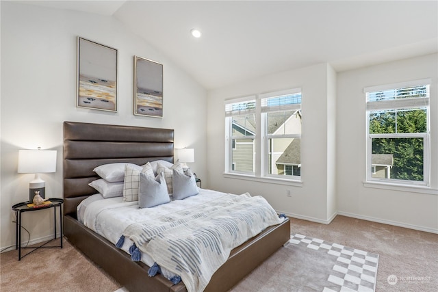 bedroom with lofted ceiling and light colored carpet