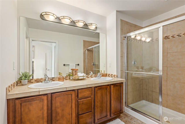 bathroom featuring vanity and a shower with shower door