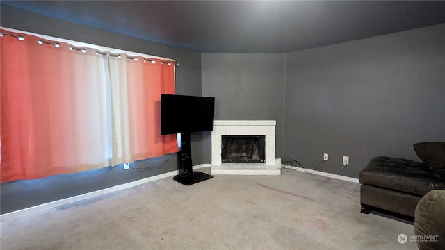 unfurnished living room with a brick fireplace and carpet