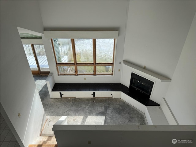 unfurnished living room with vaulted ceiling