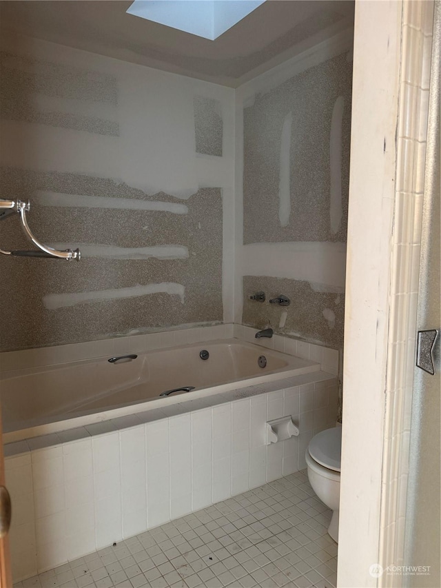 bathroom with toilet, a relaxing tiled tub, tile patterned floors, and a skylight